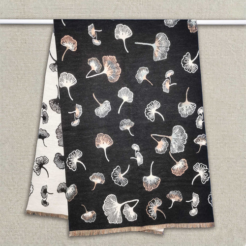 A black women scarf with ginkgo leaf pattern is hanging on clothing rack, The cashmere-feel fabric is very soft, warm and with high-quality workmanship. This fashion scarf is reversible and large size, approx. width 65 cm, length 180 cm and weight 330g