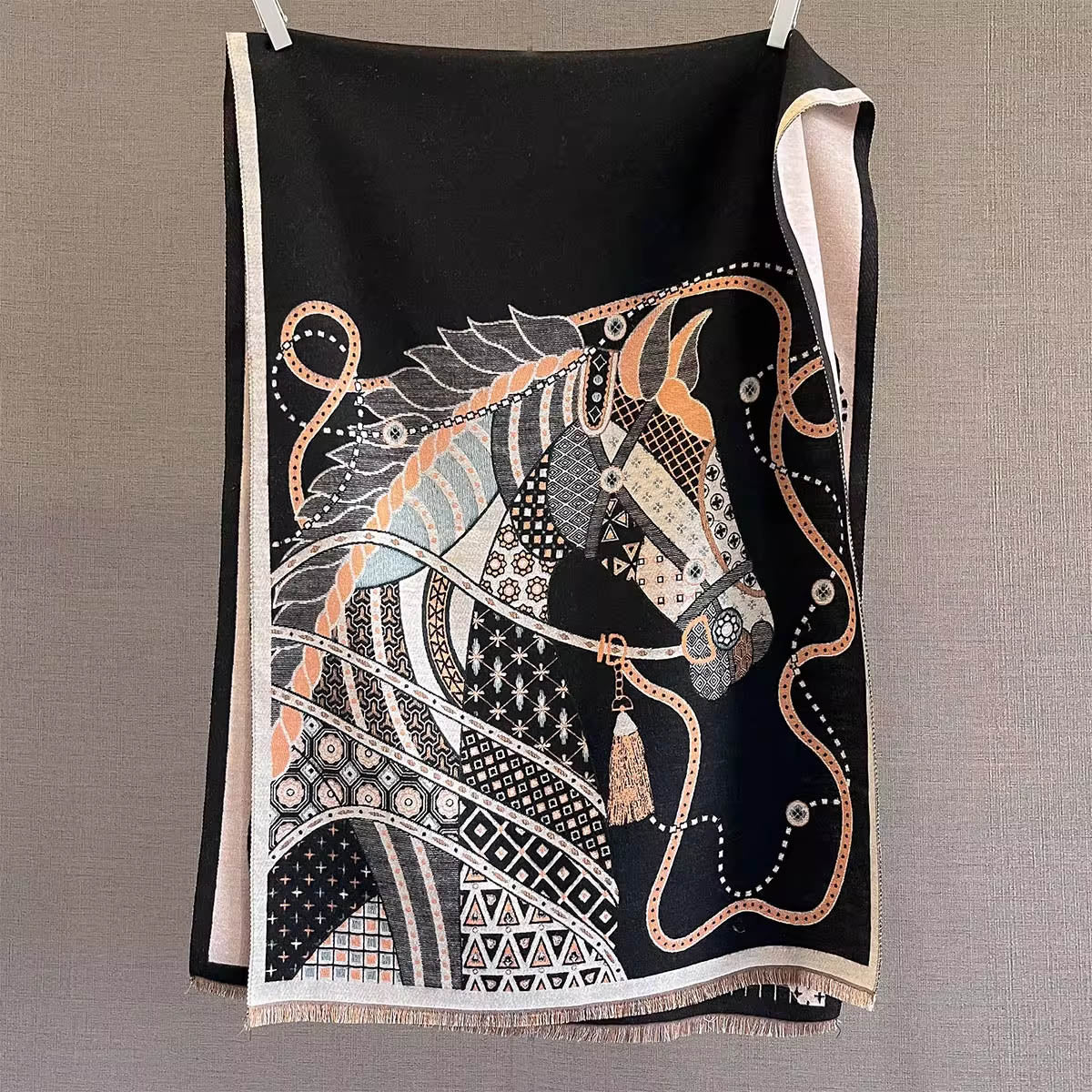 Full view of a black women scarf with horse and chains pattern is hanging on rod. The fashion winter scarf is crafted from cashmere-feel fabric that is very soft, warm and high-quality. Reversible and large size, approx. width 65 cm, length 180 cm and weight 330g