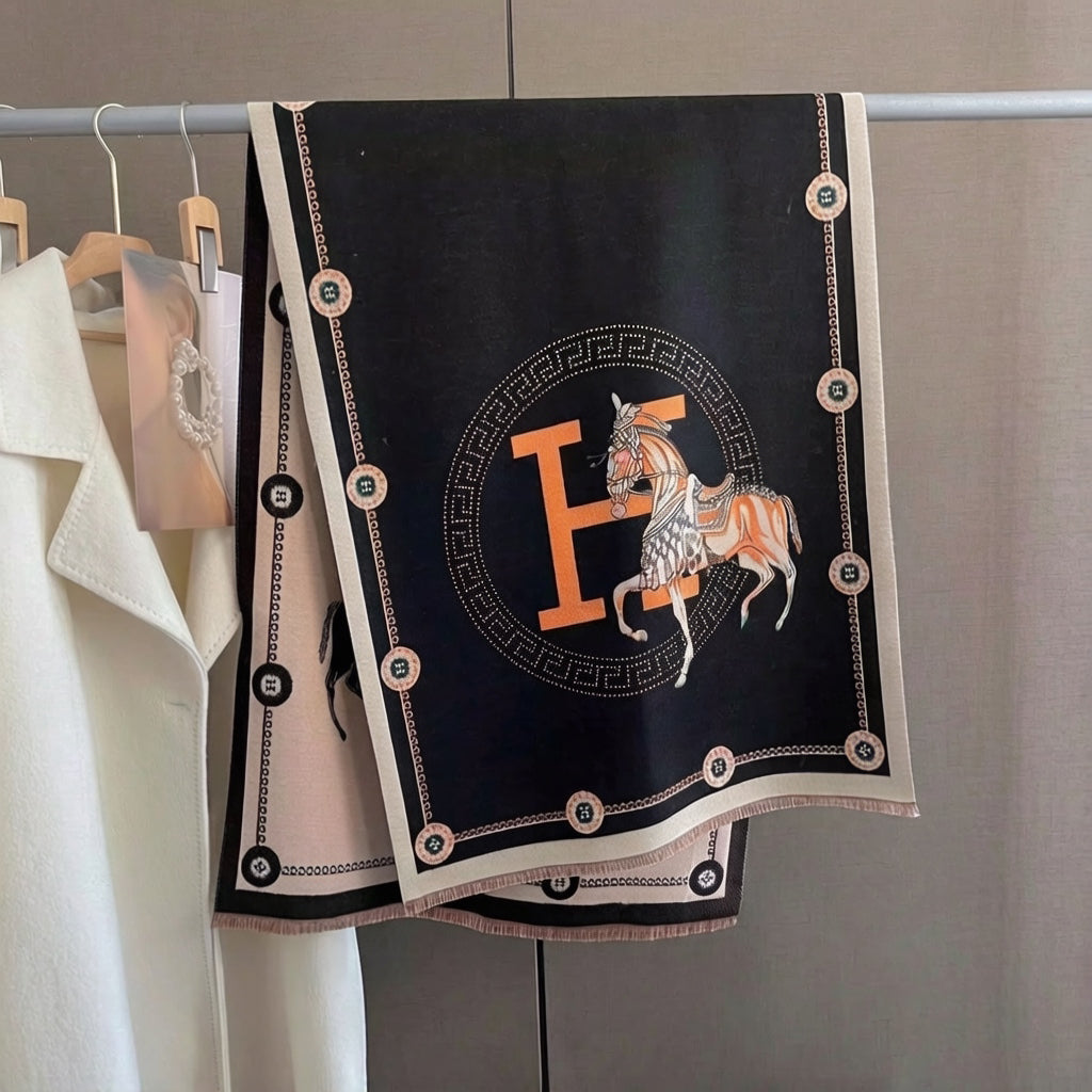 Full view of oversized black soft luxury shawl with ivory equestrian horse and border and orange letter medallion print