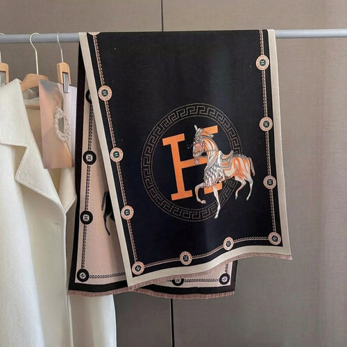 Full view of oversized black soft luxury shawl with ivory equestrian horse and border and orange letter medallion print