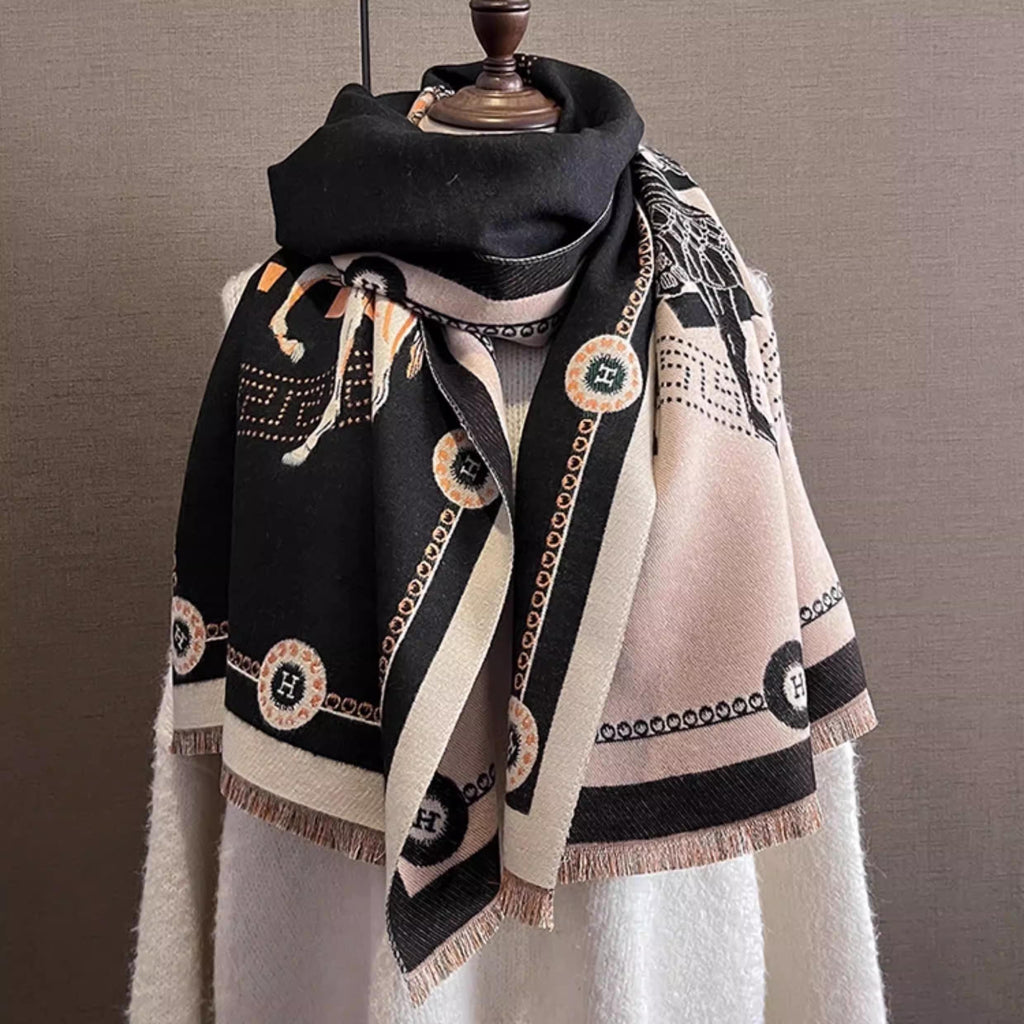 Black luxury style scarf with orange letter and ivory border, styled as winter neck wrap