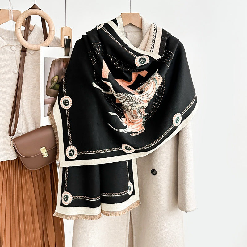 Luxuriously soft black equestrian jacquard scarf styled over a beige coat, featuring horse print and ivory border details.
