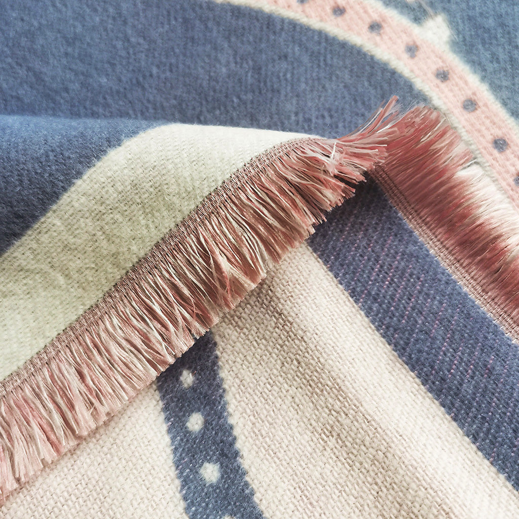 Close-up detail of the fringe of a blue cashmere-feel fashion women scarf. The fringe and fabric detail show the winter scarf is very soft and warm, and crafted from high-quality workmanship