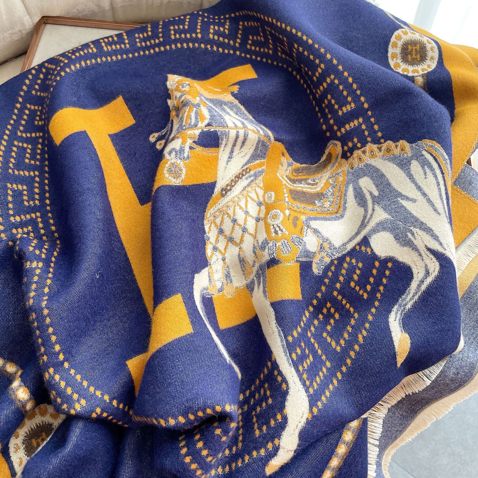 Close-up of royal blue large scarf with gold letter and border fabric, horse pattern and gold letter. The clear horse pattern showcases the exquisite craftsmanship, making it the perfect gift for any occasion.
