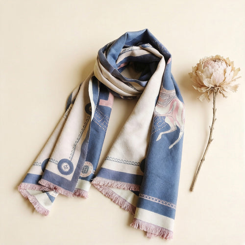 Reversible blue and pink horse print cashmere-feel scarf styled with dried flower flat lay