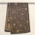 Full view of winter scarf hanging on a rod showing black and brown letter pattern design, and high-quality cashmere-feel fabric. Fashion unisex scarf. Large size, approx. 65 cm width,  180 cm length and 330g
