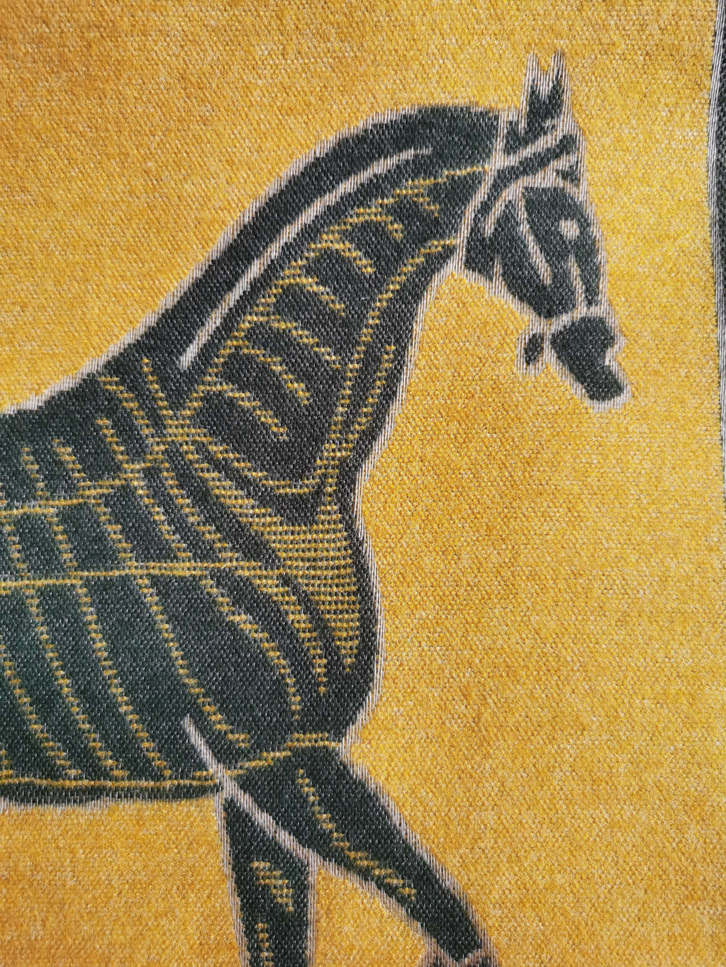 Close-up texture of a cashmere-feel men scarf. The clear horse pattern shows this fashion winter scarf is made with high-quality workmanship