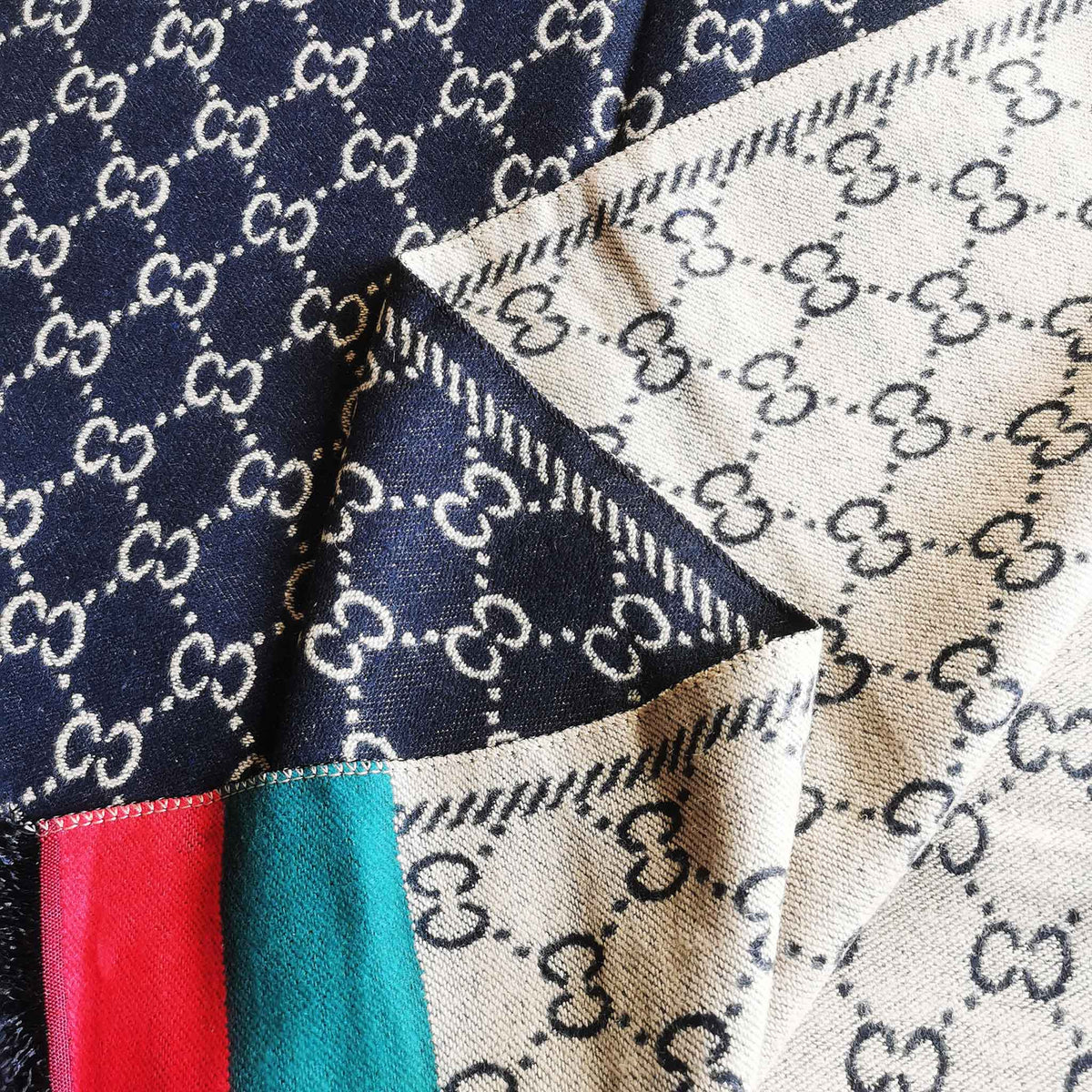 Close-up detail of a black cashmere-feel fashion women scarf. The fabric detail shows the winter scarf is reversible, very soft and warm, and crafted from high-quality workmanship