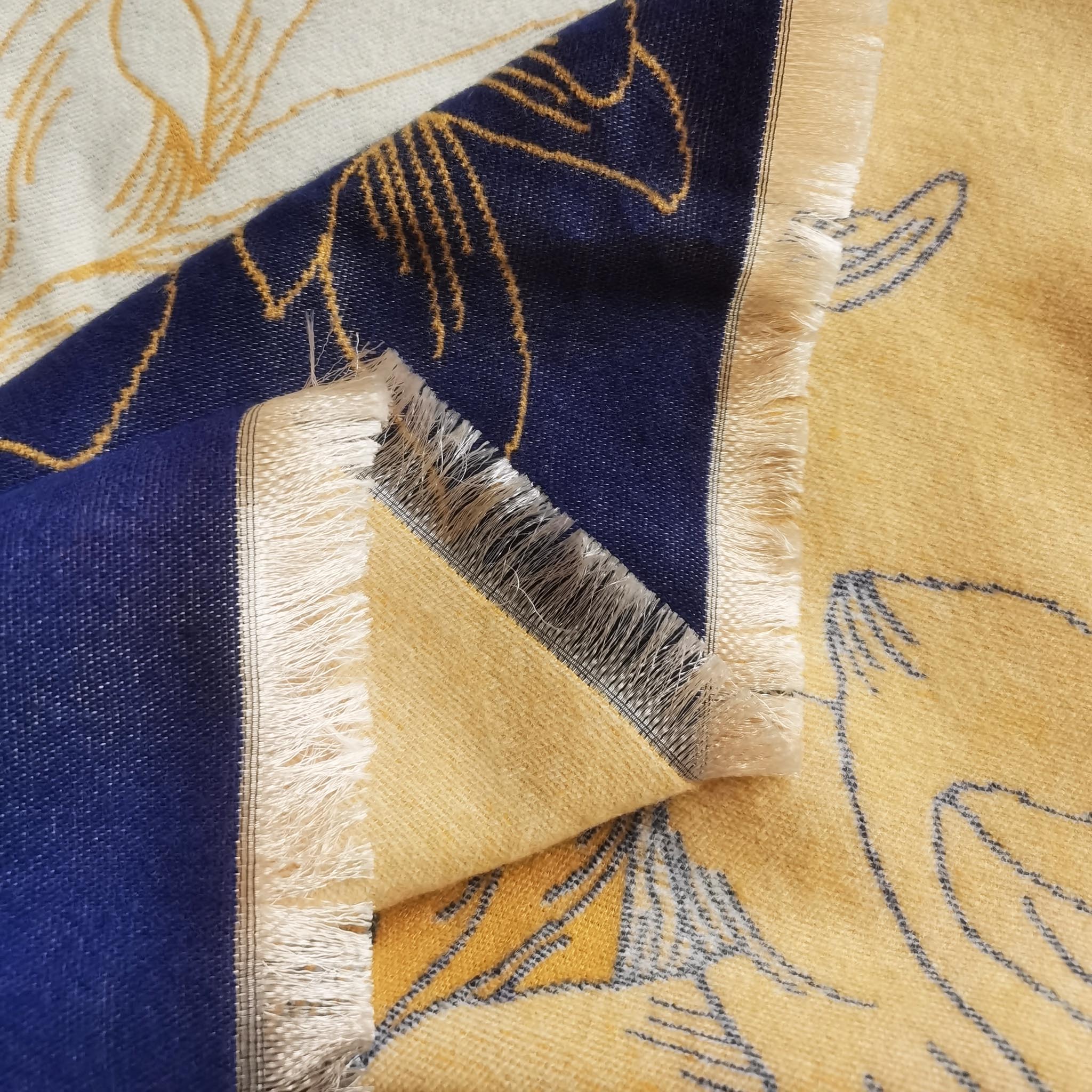 close up of women winter scarf in navy and yellow floral crafted by cashmere-feel fibric with natural fringe edge detail. The texture shows the material is pretty soft.