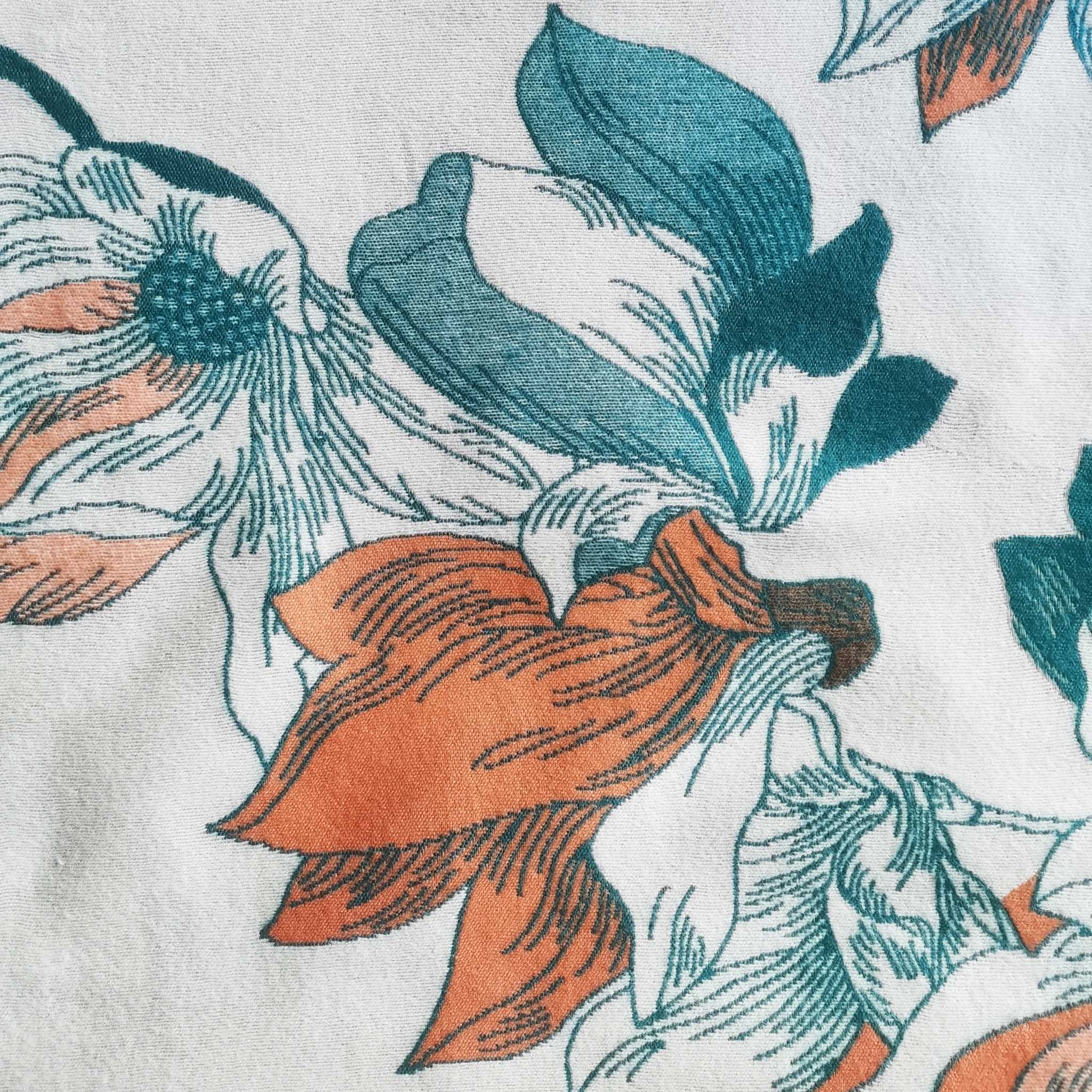 Close-up of floral print winter women scarf in teal and orange on cream background showing cashmere-feel fabric and the clear pattern crafted with high-end workmanship.