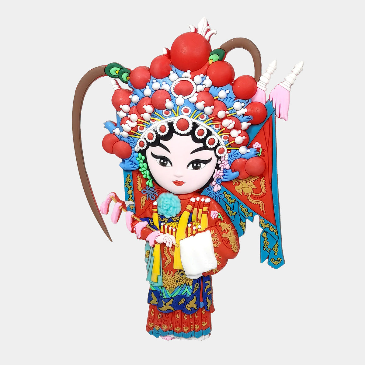 A colorful Chinese opera character magnet with a red and blue headdress, painted face, and traditional costume details. The female character featuring Fan Li Hua who is a female general in Chinese folklore.