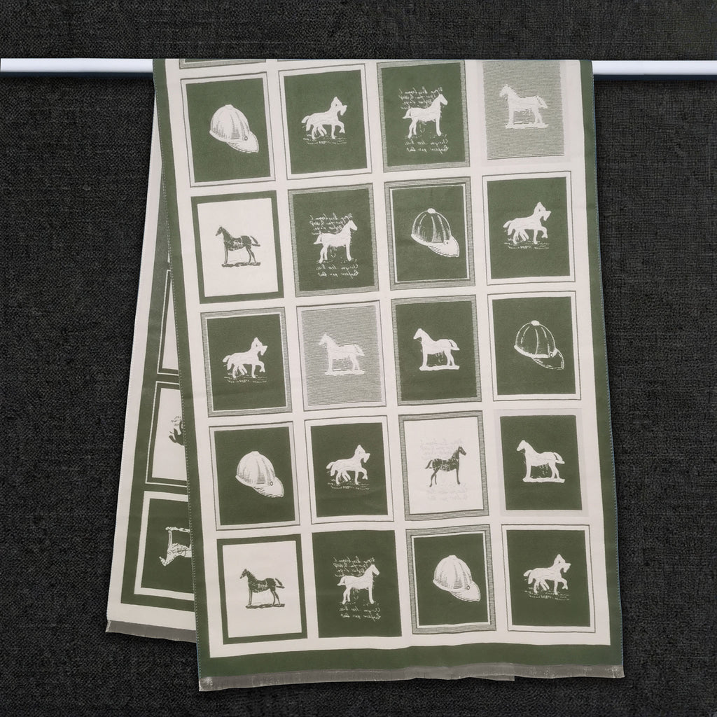 Olive green winter men scarf with horse pattern in color block is hanging on clothing rack, This large size neck scarf is reversible and crafted from cashmere-feel fabric