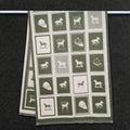 Olive green winter men scarf with horse pattern in color block is hanging on clothing rack, This large size neck scarf is reversible and crafted from cashmere-feel fabric