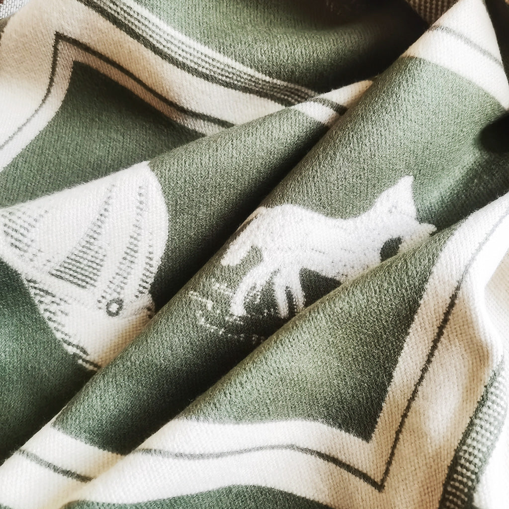Close-up texture of an olive green cashmere-feel men scarf. The fabric looks very soft and warm. The winter scarf is made with high-quality workmanship