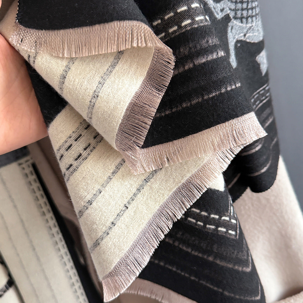 Close-up of winter women scarf with black and orange color block equestrian print showing soft cashmere-feel fabric texture with delicate fringe edge