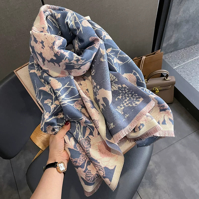 cashmere-feel winter women scarf with jacquard floral bird pattern in dusty blue and blush pink displayed as a neck scarf. It shows the scarf is a perfect fashion gift for any special occasion.
