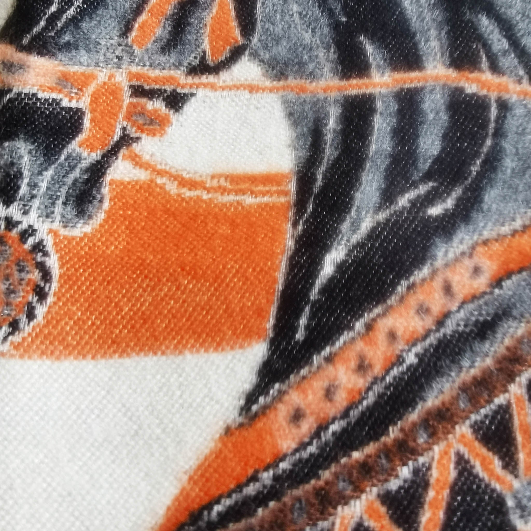 close-up of ivory large scarf fabric detail showing clear black horse pattern