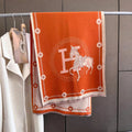 Large orange scarf with ivory border, letter and equestrian horse print. Showing super soft cashmere-feel fabric, that is a  perfect shawl for all season.
