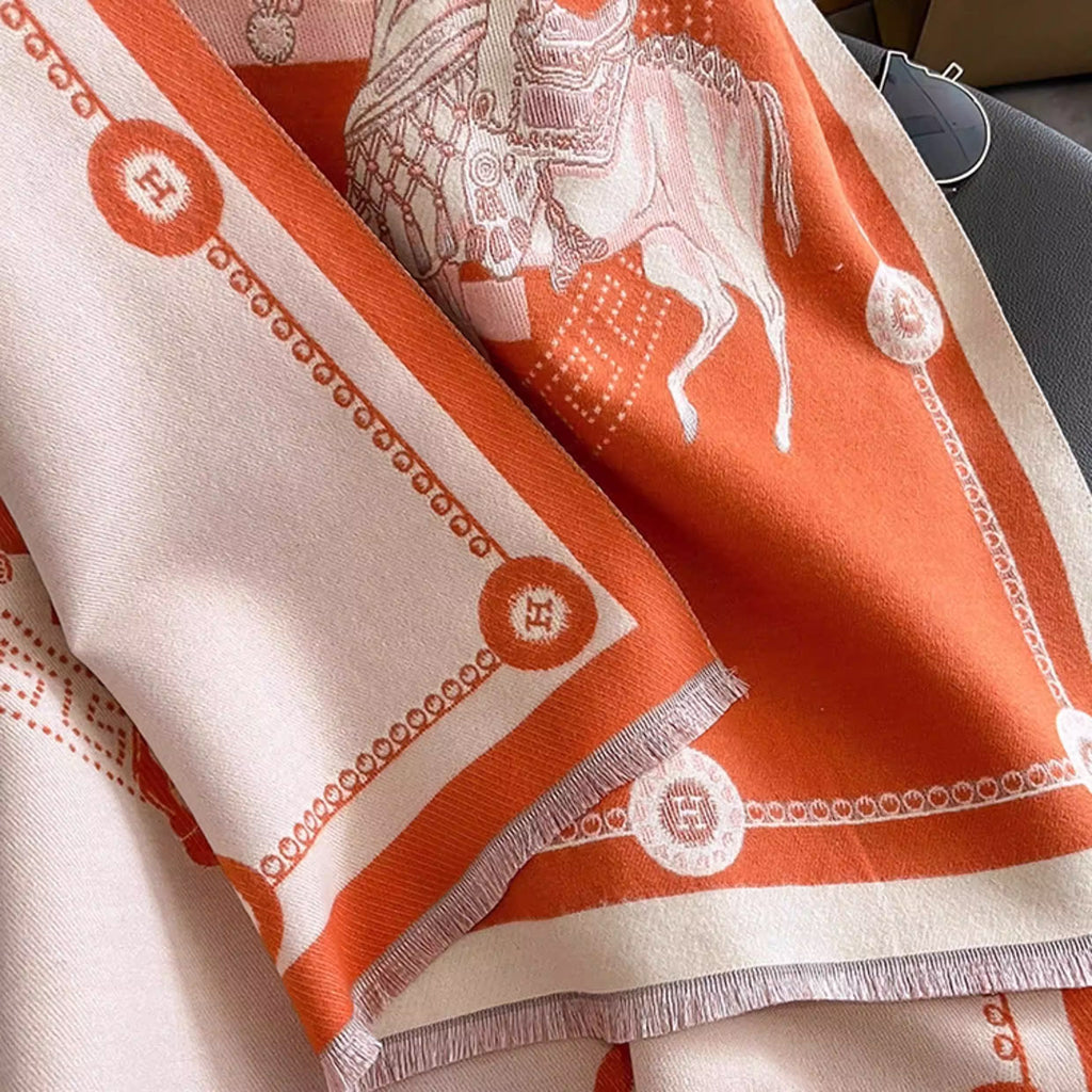 Close-up of orange luxury equestrian print soft winter scarf with fringe trim 